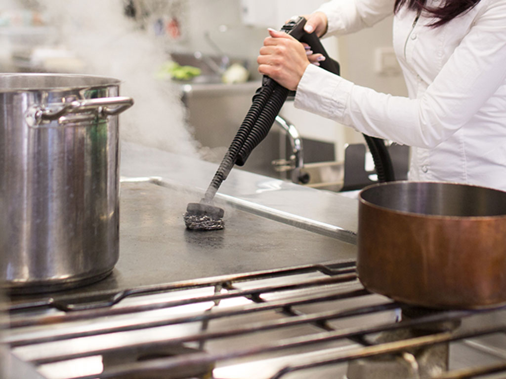 Cleaning kitchen and cooking facilities and surfaces in caravan park and campsite accommodation venues with steam vapour